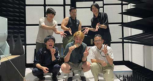 John Webb posing with Japanese coworkers